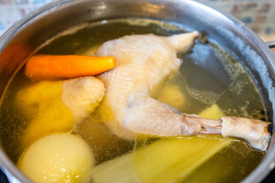 soup chicken is simmered with vegetables in pot