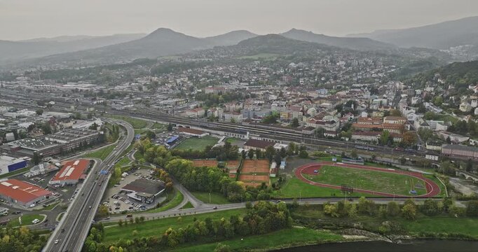 Decin Czechia Aerial v4 drone flyover Elbe river capturing highway traffics, industrial area and hillside cityscape of downtown and Podmokly neighborhood - Shot with Mavic 3 Cine - November 2022