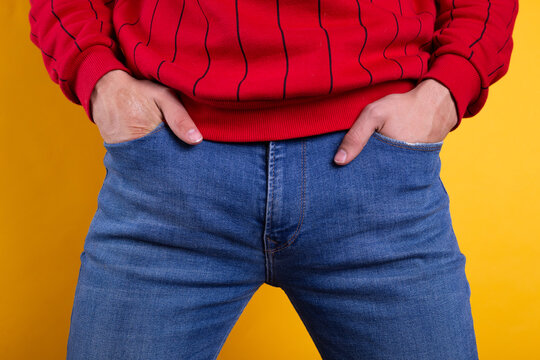 a young guy with skinny legs in jeans, below the waist: a fly and pockets for money or condoms. a pose from psychology: waiting in a store queue or on a date with a girl. street style in clothing: cla