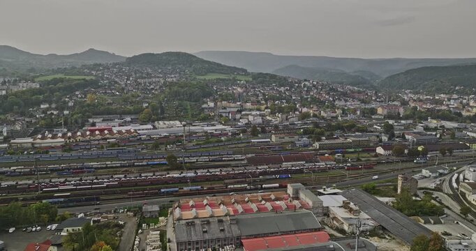 Decin Czechia Aerial v6 establishing shot drone flyover the industrial area capturing massive railway yard along Elbe river and hillside cityscape views - Shot with Mavic 3 Cine - November 2022