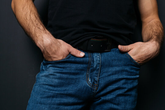a young guy with skinny legs in jeans, below the waist: a fly and pockets for money or condoms. a pose from psychology: waiting in a store queue or on a date with a girl. street style in clothing: cla