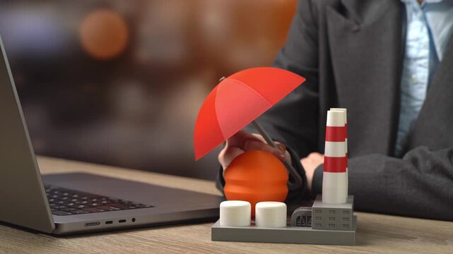 A businesswoman holds an umbrella over an industrial facility. Protecting the energy sector from drones and threats. Industrial insurance. Chemical sector. Risk mitigation and security planning
