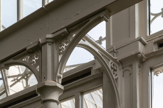 Ornate cast iron structural elements and metal railing of a historic industrial building.
