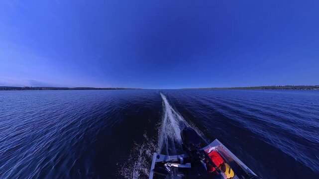 Boat wake foaming at water from outboard motor rear view. Wave from the boat moving. White foam from waves. Waves from the outboard engine at high speed boat during stunning sun set.