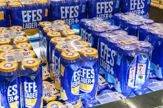 Alanya, Turkey. Efes Lager beer cans stacked in a display, showcasing vibrant blue packaging and labels in a retail environment