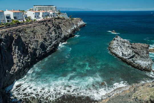 Jagged and dotted rocky coastline with amazing azure water of Tenerife Island.