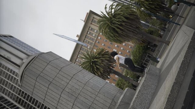 Man Doing Epic Flip And Catching Painted Board Overhead In San Francisco Plaza - Cinematic Slow Motion Shot