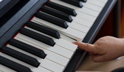 Child learning to play piano © Olena