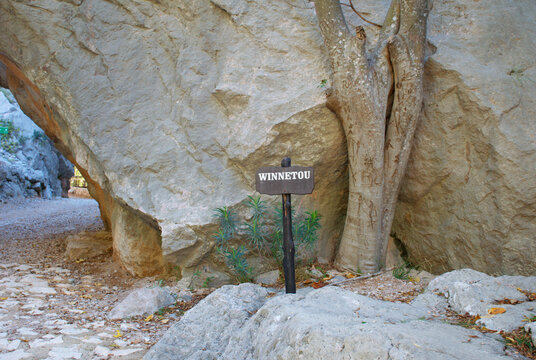 Famous Winnetou movie filming location in Paklenica National Park, Croatia. Rocky canyon with limestone cliffs, natural stone arch, trees, and hiking trail in the Velebit Mountains. 