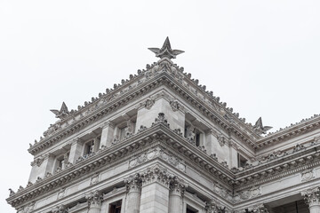 Ornate Neoclassical Building Corner with Decorative Star Finial © Richard
