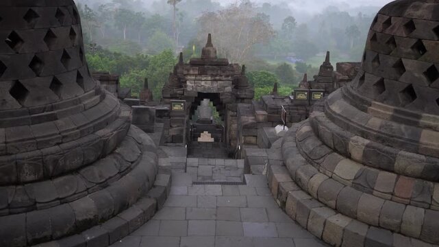 Forward Moving Shot Through Stone Archway Gate at Borobudur Temple