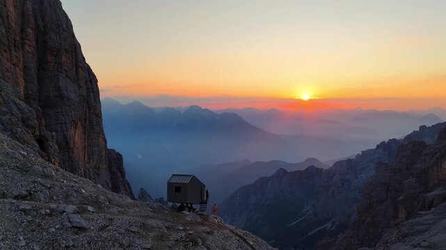 Aerial drone view of a beautiful sunrise over the majestic Dolomite Mountains. Golden morning light. Breathtaking sunrise over the Alpine landscape.