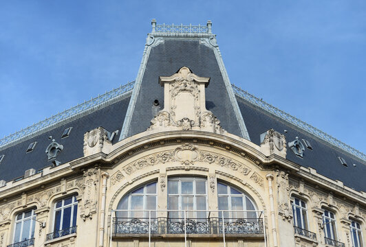 Ornate antique top gable of the famous Galeries Lafayette with blue in Dijon, France