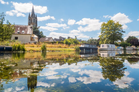 The town of &Eacute;vran and boats on Ille-et-Rance Canal in Bretagne - France