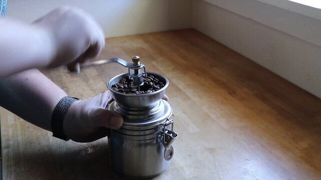 Grinding Coffee Beans by Hand in Manual Burr Mill Grinder