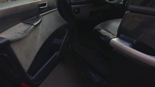 Person's hand pulling an automotive door handle, entering a car