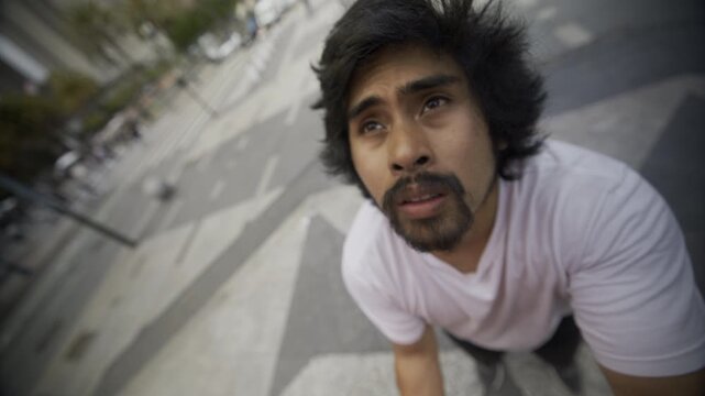 Slow Steady Cam In On Face Of Passionate Man As He Stares Up While Standing On Concrete Steps In San Francisco Plaza