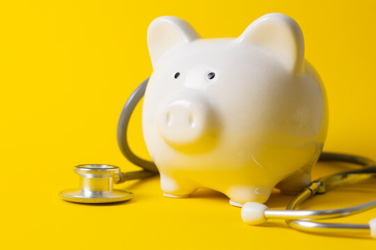 Piggy bank with stethoscope, medical finance and healthcare insurance concept