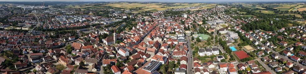 Obraz premium A panoramic aerial view beside the old town of the city Ehingen beside the danube river in Germany on a sunny summer noon. 