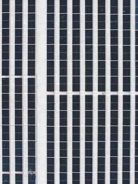 Aerial view of a large solar panel array with rows of photovoltaic modules arranged in a grid pattern in Salaspils, Salaspils Municipality, Latvia.