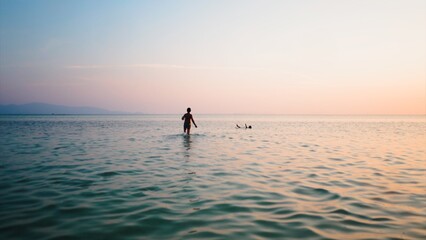Fototapeta premium Children playing in ocean water during sunset, enjoying summer vacation