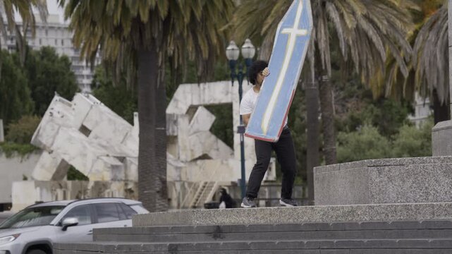 Man Doing Professional Spin Tricks on Granite Plaza Steps - Wide Shot