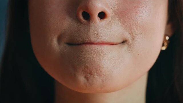 Macro lips applying red lipstick. Asian woman portrait smiling makeup.