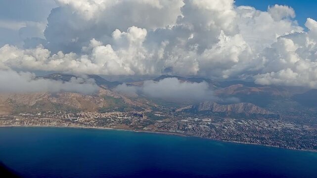 view of the sea from above. View from the window of the plane on Sicily and the sea.