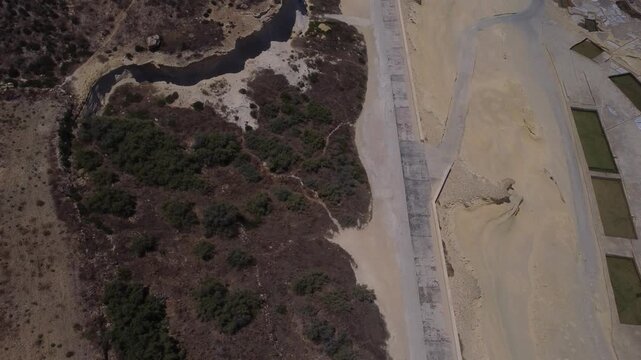 Xwejni s centuries-old salt pans unfold along the rugged coast of Zebbug, Gozo, geometric pools and vivid Mediterranean blues in a sweeping summer Aerial view. High quality 4k footage