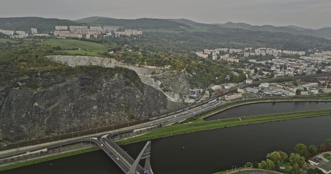 Usti nad Labem Czechia Aerial v3 flyover Elbe river across Mariansky Most bridge towards Lom Mari�nsk� Sk�la quarry site, panning reveals hillside cityscape - Shot with Mavic 3 Cine - November 2022