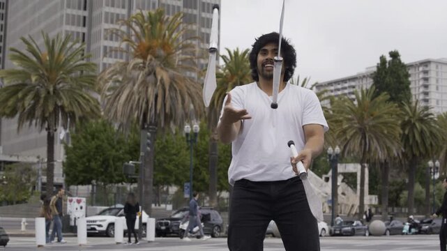 Street Juggler Smiling While Tossing Knives In San Francisco Plaza - Slow Motion, Medium Shot