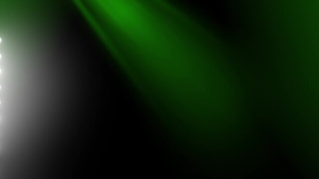 Bright stadium floodlight beam casting intense green light rays across a dark theater stage background