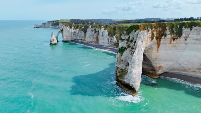 Etretat cliffs with natural arch and sea stack on Normandy coast, France. Aerial view of iconic French landmark coastline