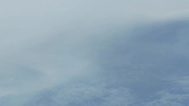 Military transport aircraft flying in cloudy sky, Airbus A400M Atlas turboprop plane silhouette overhead view