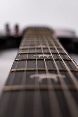 Fototapeta premium Close-up image of a modern heavy rock electric guitar, focusing on intricate details such as fret markers and string grooves Soft, diffused lighting Realistic style with high detail