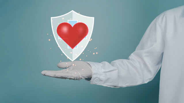 Doctor hands protecting a glowing heart with shield symbol representing cardiovascular health, medical insurance, preventive healthcare, patient safety, and digital health protection.