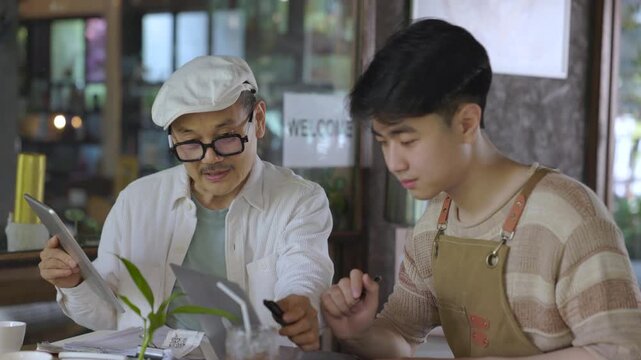 Small business, mentorship, guidance, cafe owner, senior explaining important detail while young worker listens carefully, building experience and practical knowledge through real business interaction