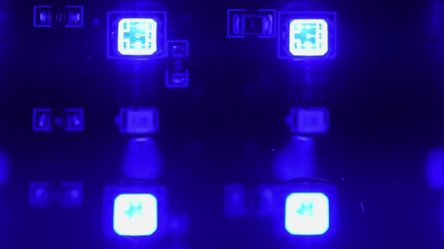 Macro close up of led light emitting diode light. Semiconductor device produces visible light while has longevity and energy savings. RGB led light panel with diodes flashing colours.
