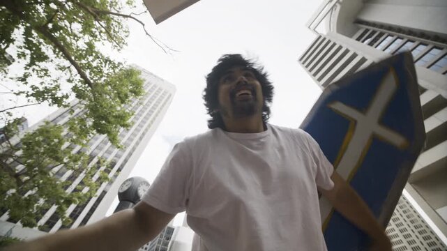 Man Raising Blue Cross Board Overhead And Spinning It On Hand In San Francisco - Low, Slow Motion Shot
