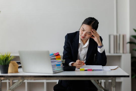 Businesswoman experiencing headache and stress from workload