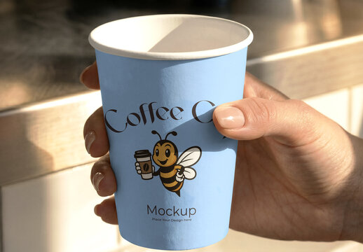 Hand Holding Paper Coffee Cup Mockup