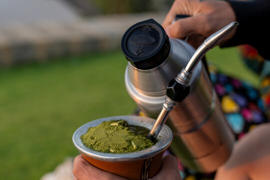 Preparing traditional yerba mate drink with hot water