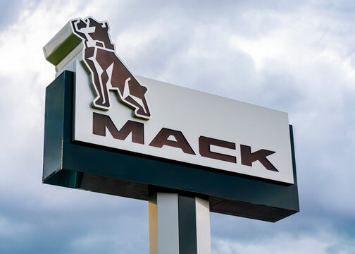 Marcy, NY - Jun 18, 2026: Evening view of Mack Utica truck dealership roadside sign located at 9580 River Road, Marcy, NY 13403, part of Mack Trucks, a heavy‑duty truck manufacturer