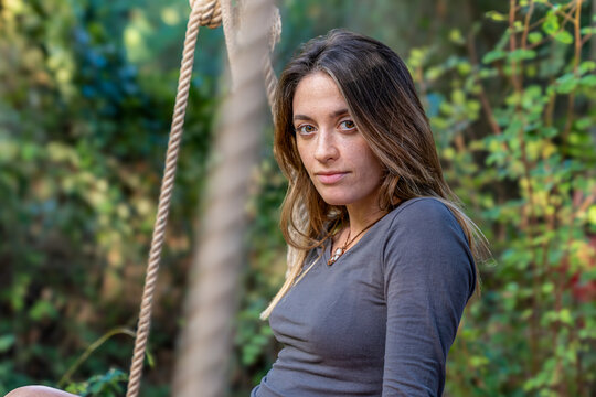 Woman with freckles looking at camera outdoors