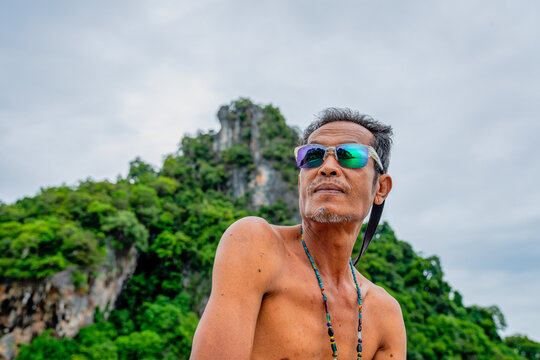Asian man wearing sunglasses on vacation in thailand