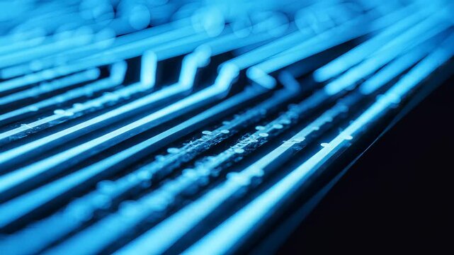 Close up of glowing blue fiber optic cables transmitting data in dark environment