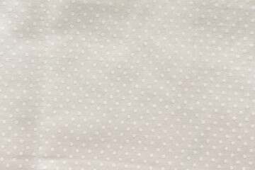 Cream cotton fabric with a small polka dot pattern © angintaravichian