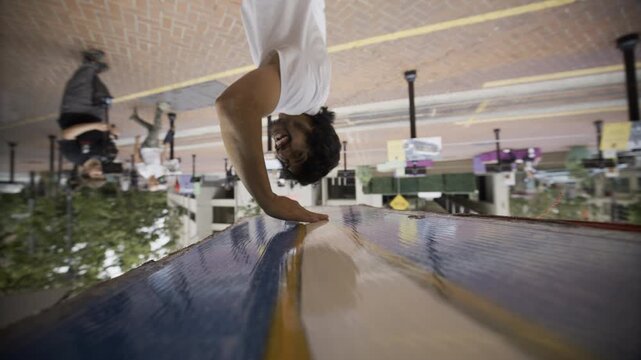 Man Holding Up Painted Board And Casually Spinning It In San Francisco Area - Slow Motion
