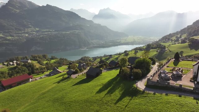 Aerial view of a scenic swiss alpine village overlooking lake walensee.
