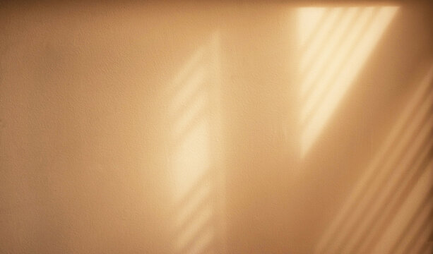 Warm sunlight casting soft window shadows on a beige wall. Creating a minimalist abstract background with natural light, texture and copy space.